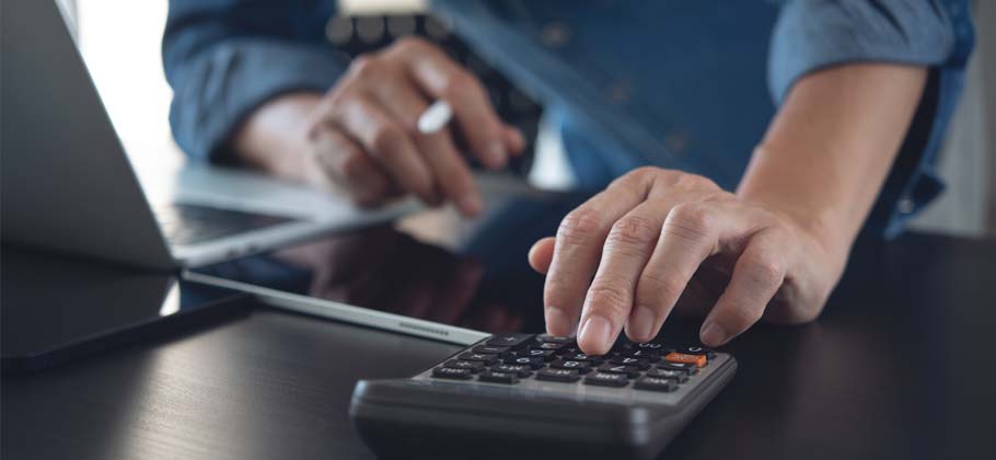 Image showing business man using calculator to calculate financial data